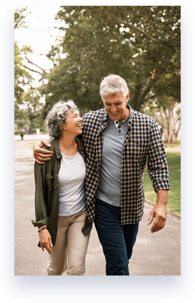 man and woman embracing and walking on path