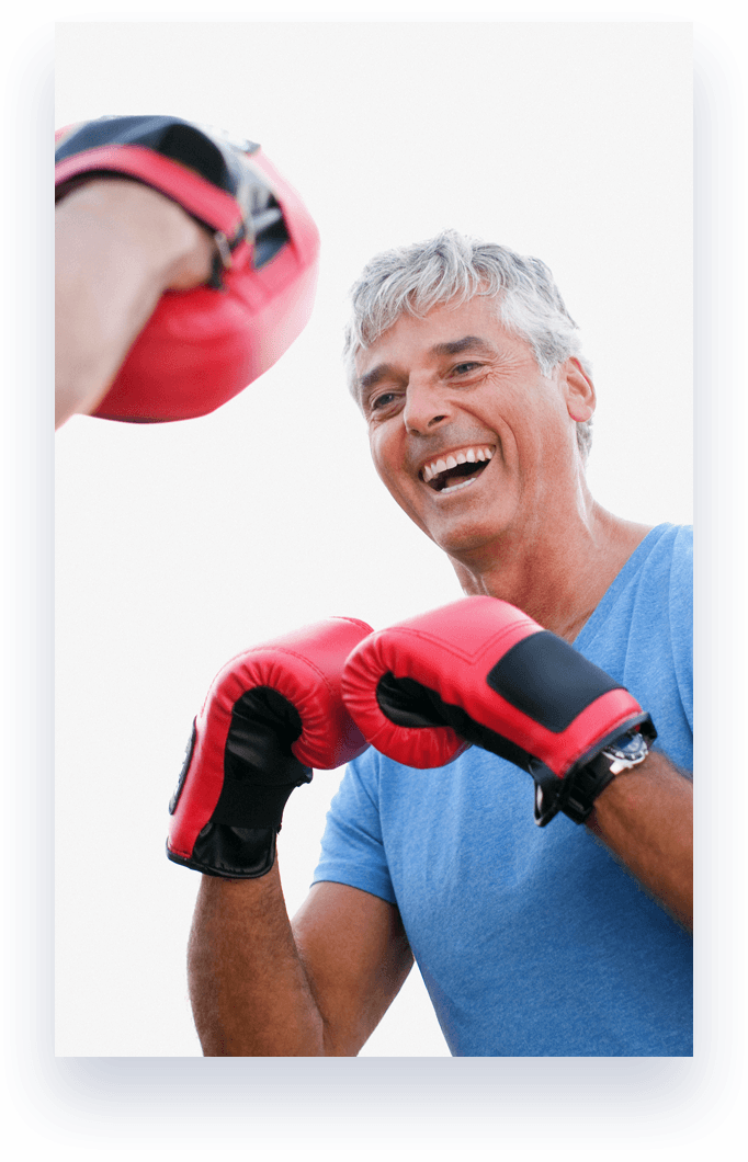 man laughing wearing boxing gloves